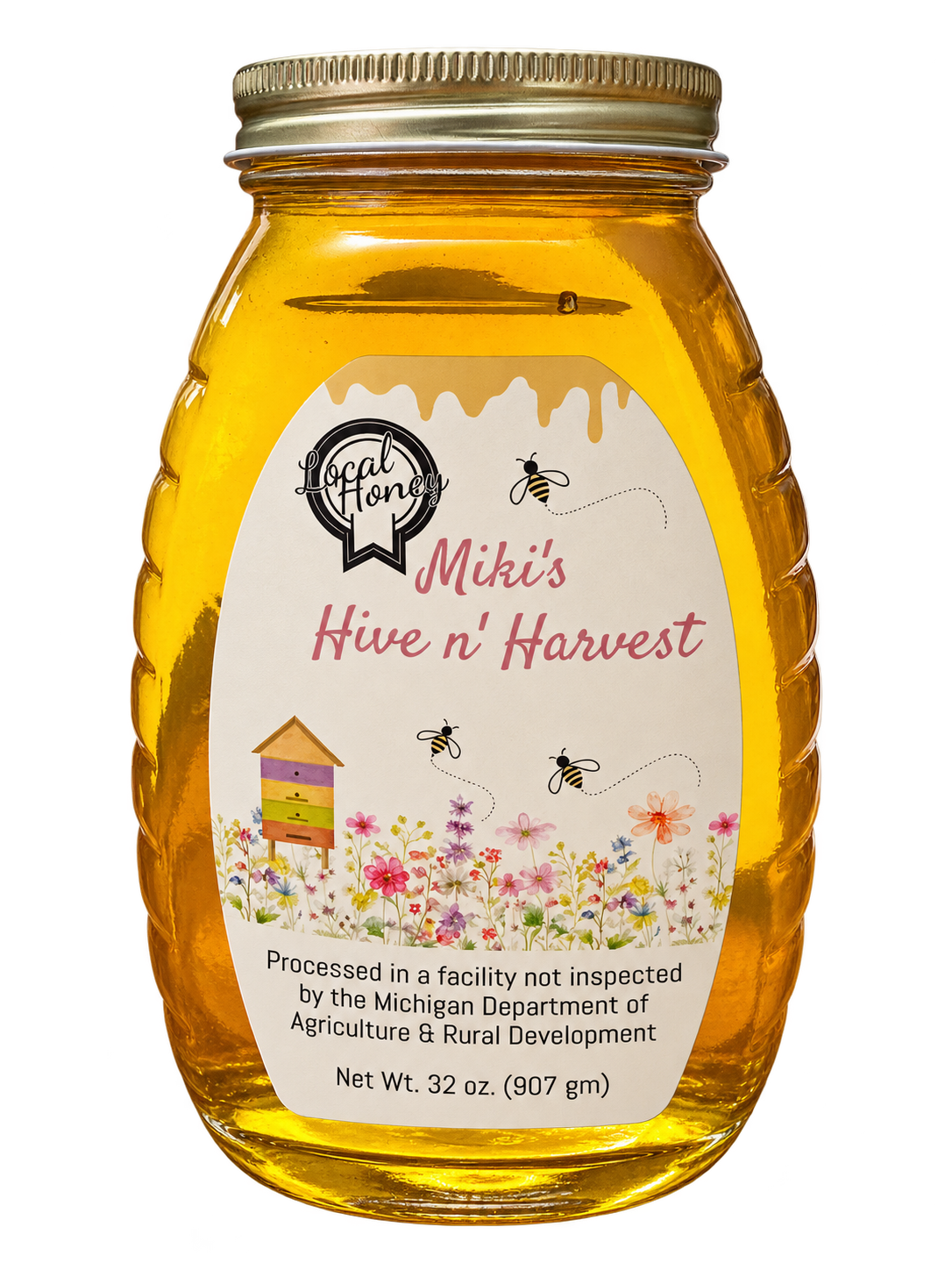 A jar of Miki’s Hive n’ Harvest honey with a floral label